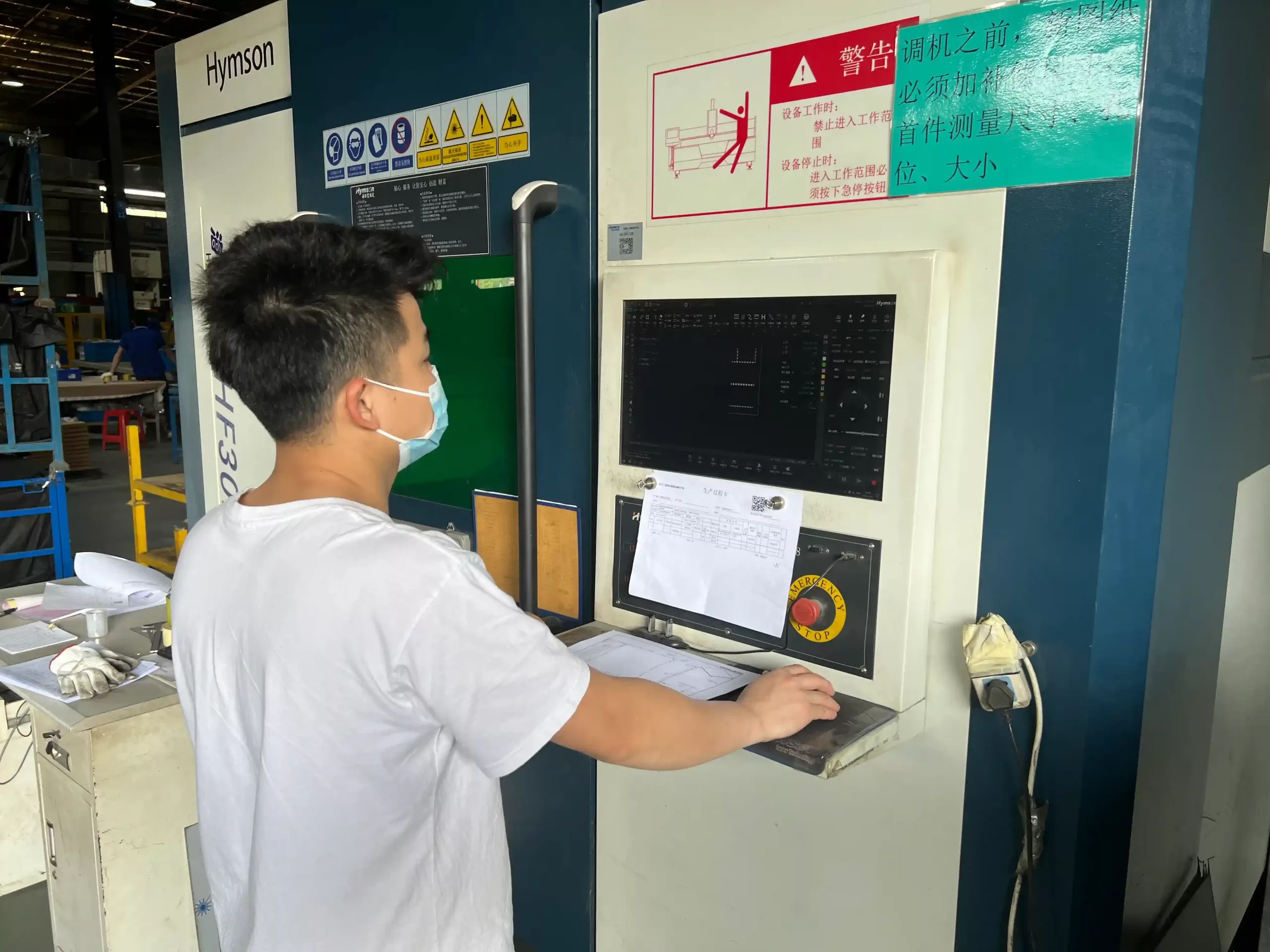 Laser cutting engineer is checking the technical drawings on site