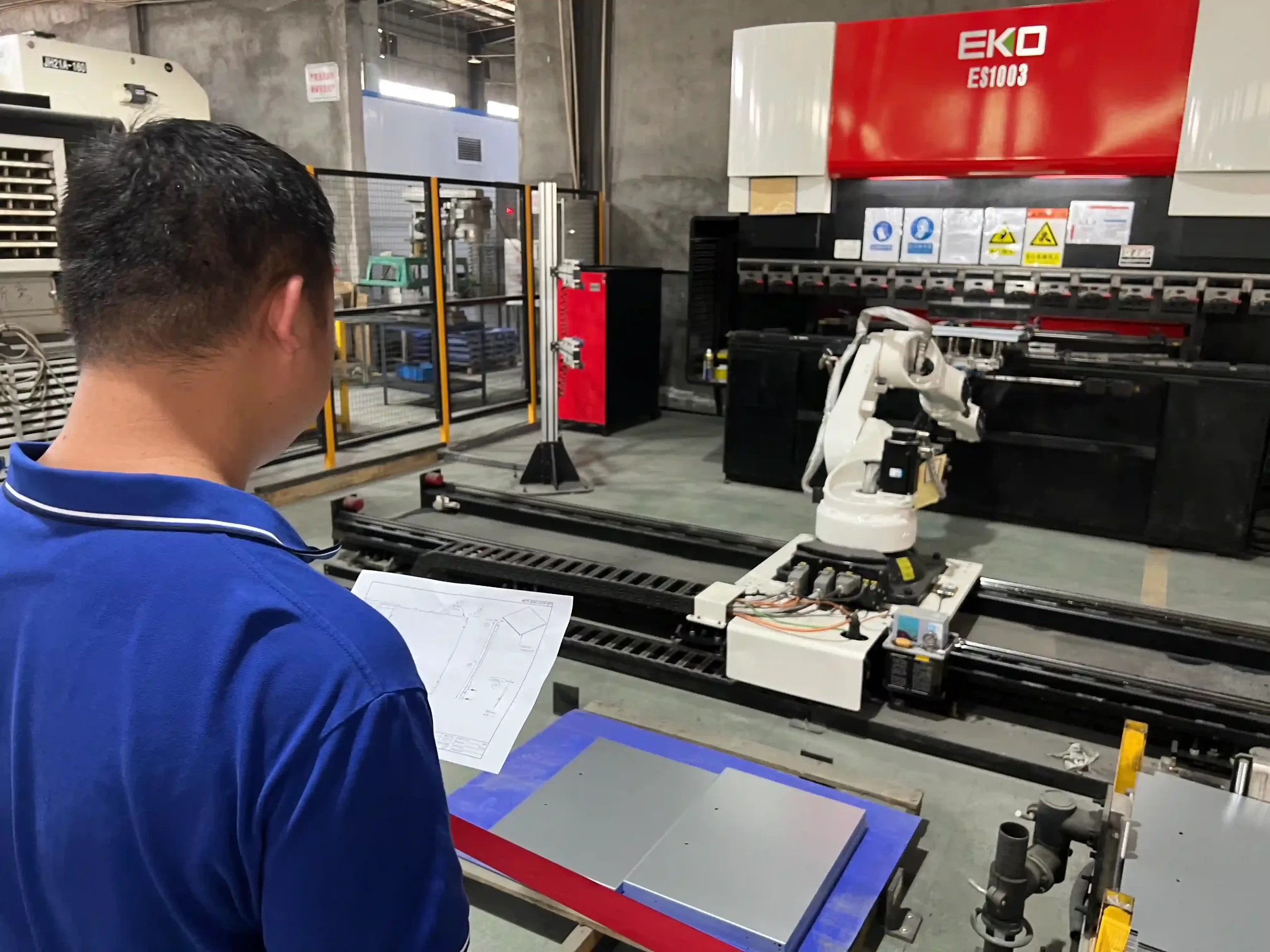 The bending engineer is on-site to review the technical drawings