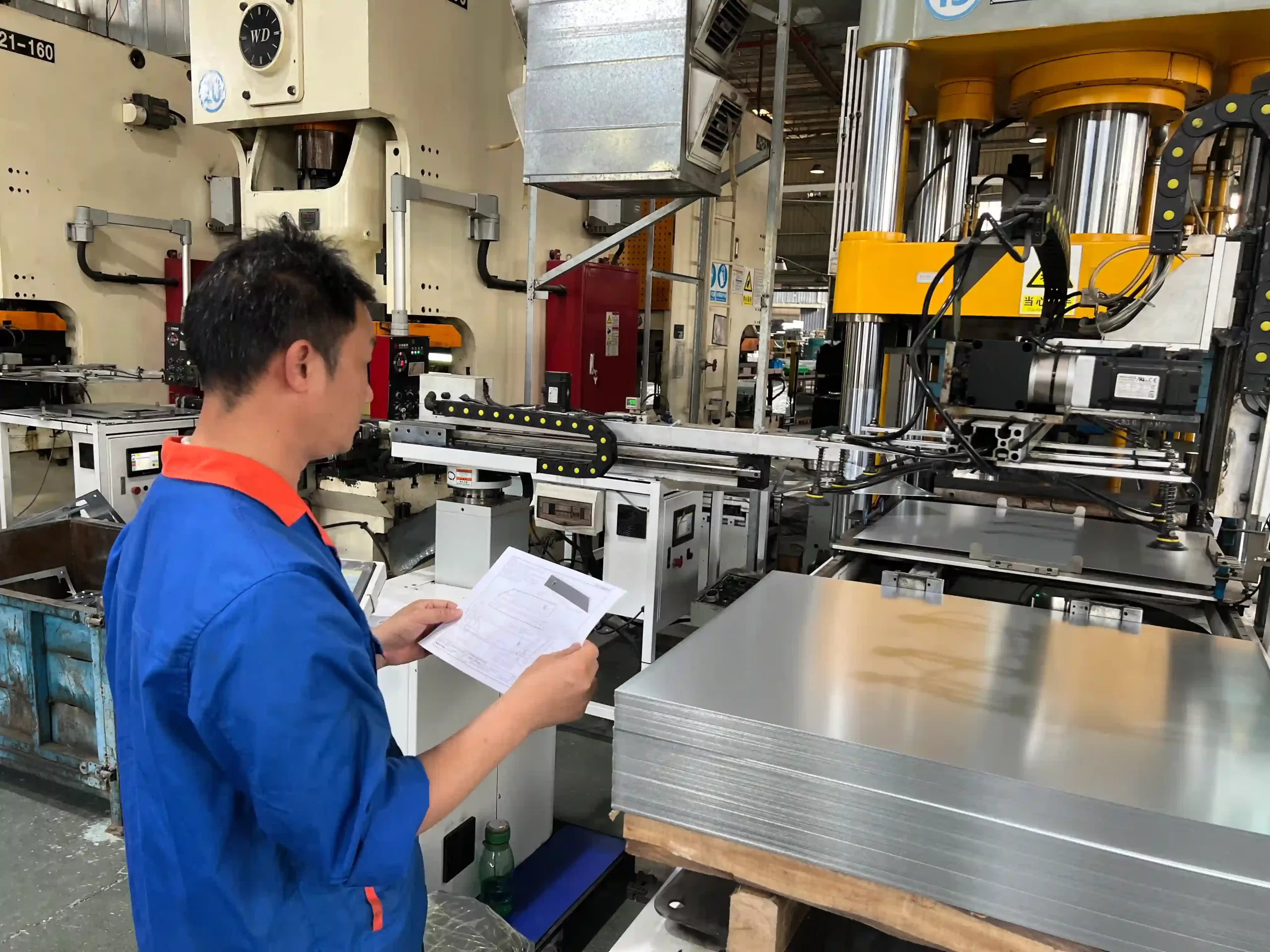 The stamping engineer is on-site to review the technical drawings