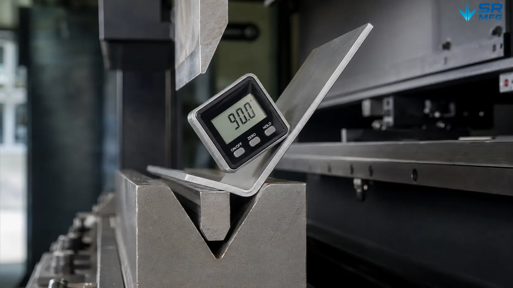 Digital angle gauge measuring bend accuracy on a sheet metal bracket during press brake forming inspection