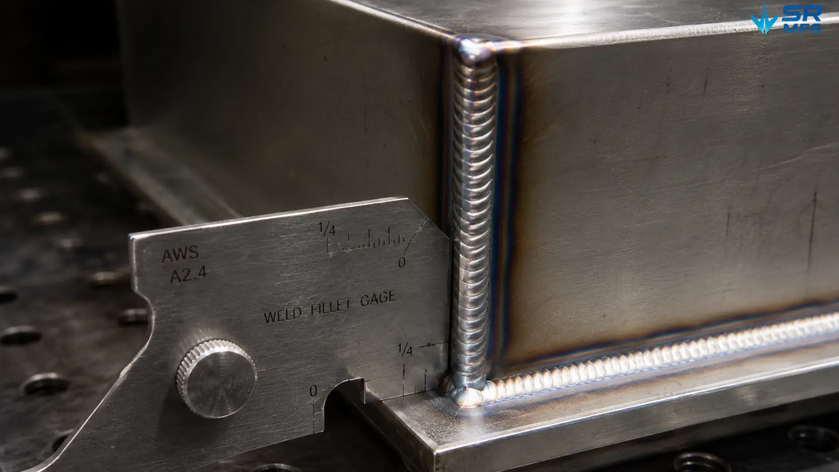 Weld fillet gauge measuring leg length on a TIG-welded stainless steel corner joint during visual weld inspection