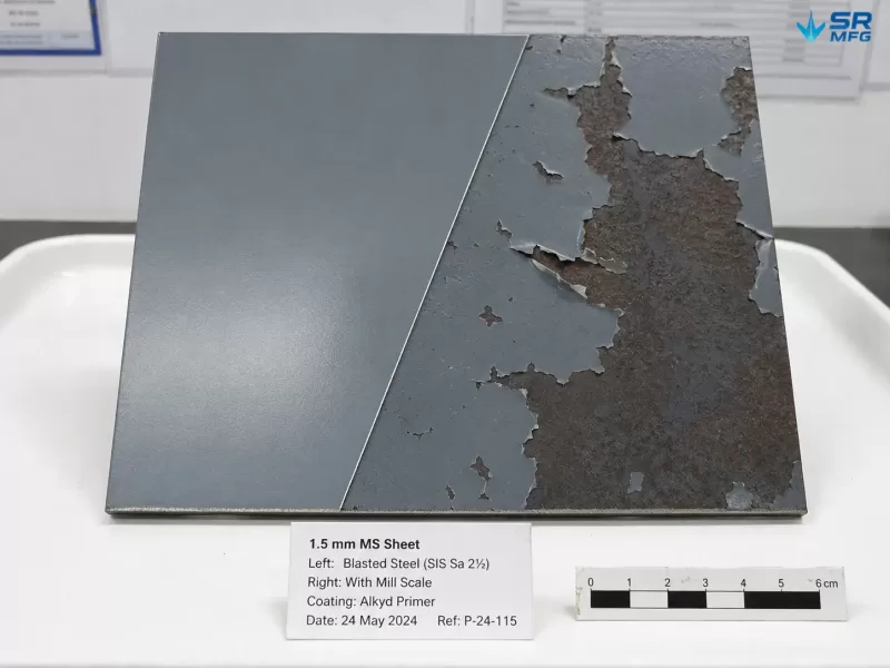 Split comparison of paint adhesion on properly prepared versus poorly prepared 1.5mm mild steel sheet showing coating failure from mill scale contamination