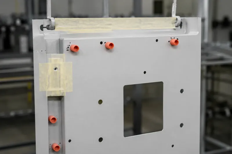 Silicone plugs and masking tape protecting threaded holes before powder coating